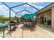 Enjoy outdoor dining and relaxation on the spacious screened-in patio with comfortable seating and outdoor cooking at 3986 Se 43Rd Cir, Ocala, FL 34480