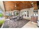 Covered patio featuring an outdoor kitchen, dining area, and comfortable seating overlooking the beautiful pool at 3986 Se 43Rd Cir, Ocala, FL 34480