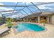 A screened-in pool and patio offer a luxurious outdoor living space with a relaxing spa at 3986 Se 43Rd Cir, Ocala, FL 34480