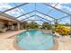 This screened-in pool area offers an inviting outdoor space with a tranquil spa and a lovely patio at 3986 Se 43Rd Cir, Ocala, FL 34480