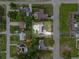 Aerial view of a beautiful property with a pool, solar panels, and well-maintained landscaping at 460 E Haines Blvd, Lake Alfred, FL 33850