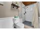 Well-lit bathroom with modern toilet, wainscoting, and walk-in shower with neutral accents at 460 E Haines Blvd, Lake Alfred, FL 33850