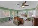 Comfortable bedroom with natural light, ceiling fan, and vintage furniture at 460 E Haines Blvd, Lake Alfred, FL 33850