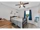 Serene bedroom with ample sunlight, ceiling fan, nautical decor, and light gray walls at 460 E Haines Blvd, Lake Alfred, FL 33850