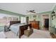 Charming bedroom features a ceiling fan, and ample natural light from the large windows at 460 E Haines Blvd, Lake Alfred, FL 33850
