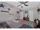 Inviting bedroom features an american flag quilt and patriotic wall decor and a ceiling fan at 460 E Haines Blvd, Lake Alfred, FL 33850