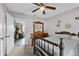 Cozy bedroom with natural lighting, ceiling fan, and an open doorway to the living room at 460 E Haines Blvd, Lake Alfred, FL 33850