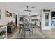 Open-concept dining area seamlessly connects to a modern kitchen with stainless steel appliances and ample counter space at 460 E Haines Blvd, Lake Alfred, FL 33850