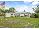 Charming single-story home with a well-manicured lawn, solar panels, and a welcoming front porch at 460 E Haines Blvd, Lake Alfred, FL 33850