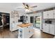 Charming kitchen featuring white cabinets, an island, stainless steel appliances and a view to the backyard at 460 E Haines Blvd, Lake Alfred, FL 33850