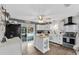 Bright kitchen with white cabinets, an island, stainless steel appliances and plenty of counter space at 460 E Haines Blvd, Lake Alfred, FL 33850