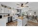 Open kitchen with an island, stainless steel appliances, and a view to the dining and living room at 460 E Haines Blvd, Lake Alfred, FL 33850