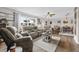 Bright living room with a decorative rug, ceiling fan, and comfortable seating arrangement at 460 E Haines Blvd, Lake Alfred, FL 33850