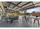 Inviting outdoor patio featuring an outdoor kitchen, dining area, string lights, and a sparkling pool view at 460 E Haines Blvd, Lake Alfred, FL 33850