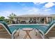 Inviting pool area with comfortable lounge chairs and a covered patio, ideal for relaxation and outdoor gatherings at 460 E Haines Blvd, Lake Alfred, FL 33850