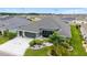 Aerial shot of the home and yard with lush landscaping and a well-manicured lawn at 488 Seth Run, The Villages, FL 32163