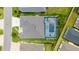 A bird's eye view of the house and screened-in pool, surrounded by green spaces and backyard oasis at 488 Seth Run, The Villages, FL 32163