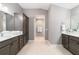 Spacious bathroom with double vanities, tile floor, and neutral paint at 488 Seth Run, The Villages, FL 32163