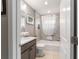 The bathroom features a bathtub and shower with gray tile, and modern vanity with white basin sink at 488 Seth Run, The Villages, FL 32163