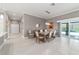 Dining area with sliding doors, neutral decor, and access to the backyard pool at 488 Seth Run, The Villages, FL 32163