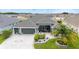 A beautifully landscaped home with a three-car garage and appealing front yard at 488 Seth Run, The Villages, FL 32163