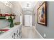 Elegant foyer featuring tiled flooring, a decorative console table, and a view of the front door and hallway at 488 Seth Run, The Villages, FL 32163