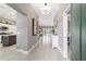 Bright foyer with tiled floors leading to an open floor plan, showcasing the kitchen, dining area, and living space at 488 Seth Run, The Villages, FL 32163