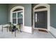 Welcoming front entrance with stylish chairs, a decorative door, and tiled flooring at 488 Seth Run, The Villages, FL 32163