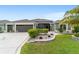 Beautiful single-story home with lush landscaping, a three-car garage, and a paver walkway to the front entrance at 488 Seth Run, The Villages, FL 32163