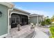 Charming front porch with a screened enclosure, tiled patio, and an elegant water fountain, perfect for relaxing outdoors at 488 Seth Run, The Villages, FL 32163