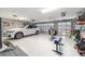 Spacious three car garage featuring an epoxy floor and organized storage at 488 Seth Run, The Villages, FL 32163