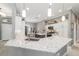 Bright kitchen with white cabinets, quartz countertops, and stainless steel appliances at 488 Seth Run, The Villages, FL 32163
