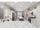 Well-lit kitchen boasts stainless steel appliances, granite countertops, and a stylish island at 488 Seth Run, The Villages, FL 32163