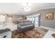 Cozy living room with access to the outdoor patio, featuring a comfortable reclining sofa at 488 Seth Run, The Villages, FL 32163