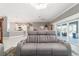 Open-concept living room with tile flooring and modern furnishings, seamlessly connected to the kitchen at 488 Seth Run, The Villages, FL 32163
