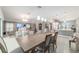 Open concept layout with combined living, dining, and kitchen areas in a well-lit home at 488 Seth Run, The Villages, FL 32163