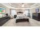 Spacious main bedroom featuring a tray ceiling, carpet, and ample furniture at 488 Seth Run, The Villages, FL 32163