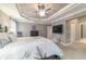 Spacious main bedroom featuring a tray ceiling, a ceiling fan, and ensuite at 488 Seth Run, The Villages, FL 32163