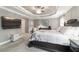 Spacious main bedroom boasts a tray ceiling, ceiling fan, and large tv at 488 Seth Run, The Villages, FL 32163