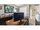 The office features a light gray paint, an area rug, and a large, wooden desk with a black office chair at 488 Seth Run, The Villages, FL 32163