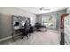 This home office features neutral walls and carpet, modern grey desks, and two black desk chairs at 488 Seth Run, The Villages, FL 32163