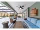 Relaxing outdoor patio area with wicker furniture, ceiling fans and screened enclosure at 488 Seth Run, The Villages, FL 32163