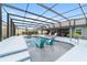 Enjoy the screened-in pool with lounge seating and in-pool chairs, perfect for relaxing and entertaining in your private backyard oasis at 488 Seth Run, The Villages, FL 32163