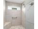 Beautiful tile shower with bench seat and small window at 488 Seth Run, The Villages, FL 32163