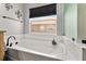 Bright bathroom featuring a soaking tub with black faucet and fixtures at 5133 Sw 41St Pl, Ocala, FL 34474