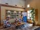 Cozy lobby area featuring comfortable seating, decorative shelving, and natural light from a nearby window at 5133 Sw 41St Pl, Ocala, FL 34474