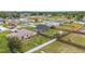 An aerial view of a single Gathering home with a fenced back yard and green grass at 63 Walnut Crse, Ocala, FL 34480