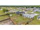 An aerial view of a single Gathering home with a fenced back yard and green grass at 63 Walnut Crse, Ocala, FL 34480
