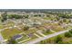 Wide aerial shot of homes in a neighborhood with mature trees and grassy lawns at 63 Walnut Crse, Ocala, FL 34480