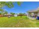 Expansive backyard with a covered patio area and storage shed, great for outdoor activities at 63 Walnut Crse, Ocala, FL 34480